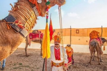 man standing under camels head